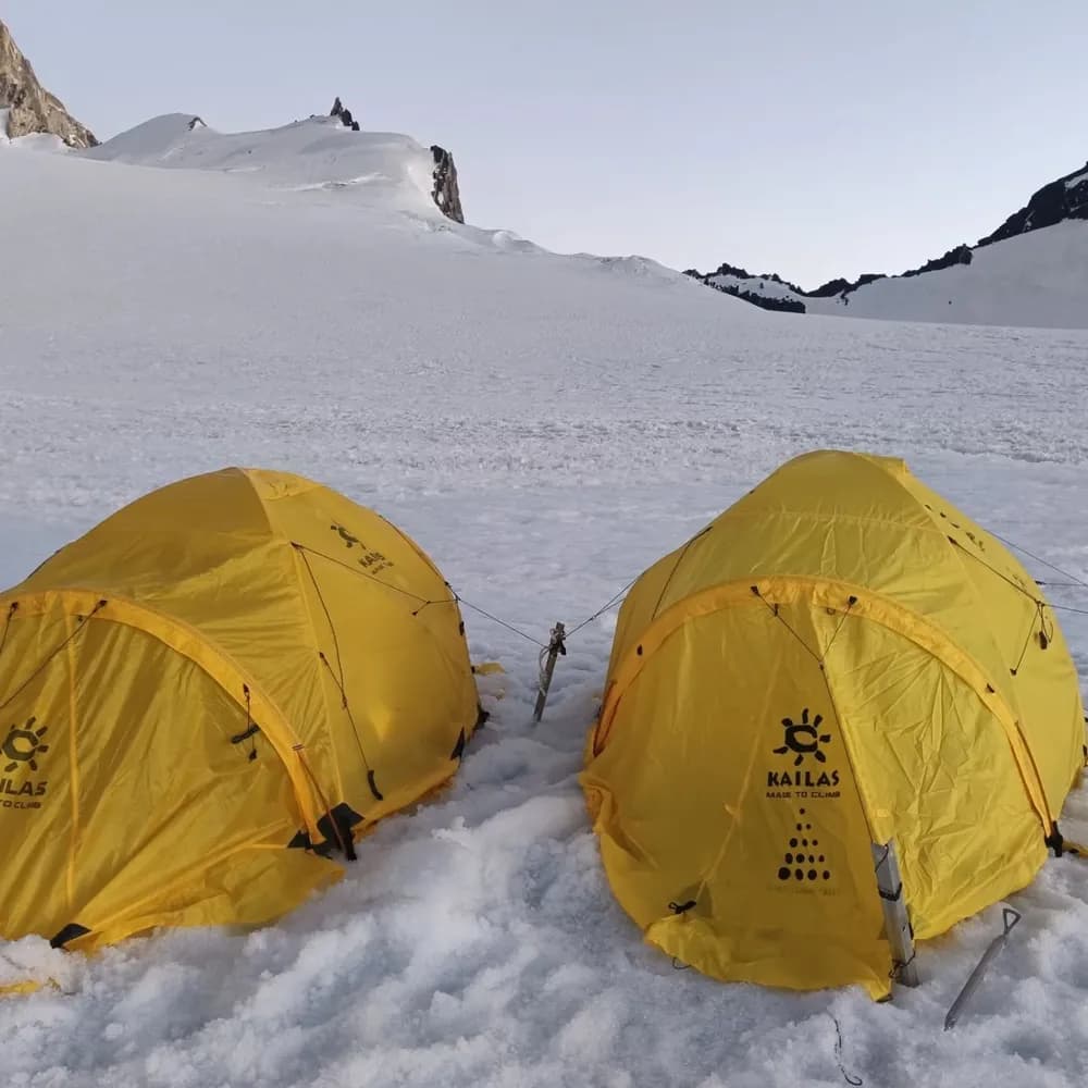 Two expedition tents at a snow-covered high camp